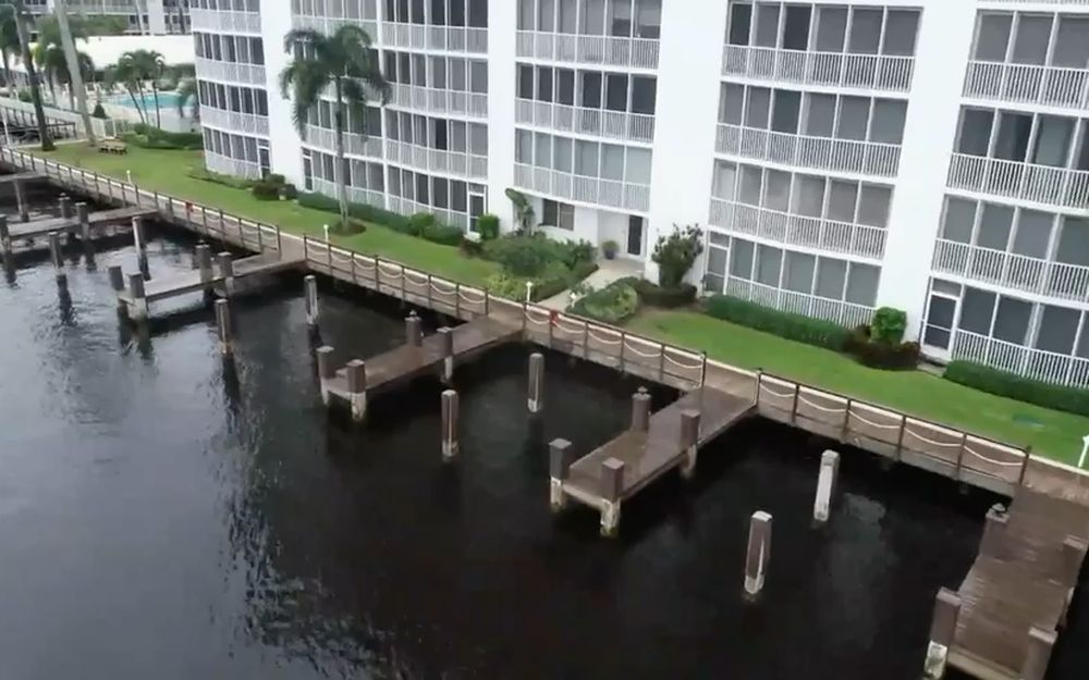 Dock pilings standing along a South Florida condominium waterfront